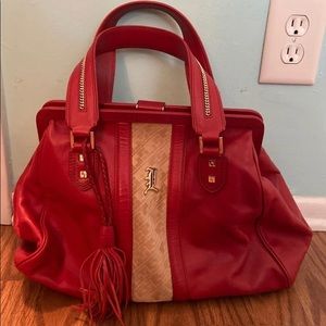 L.a.m.b red purse with beige snakeskin pattern.